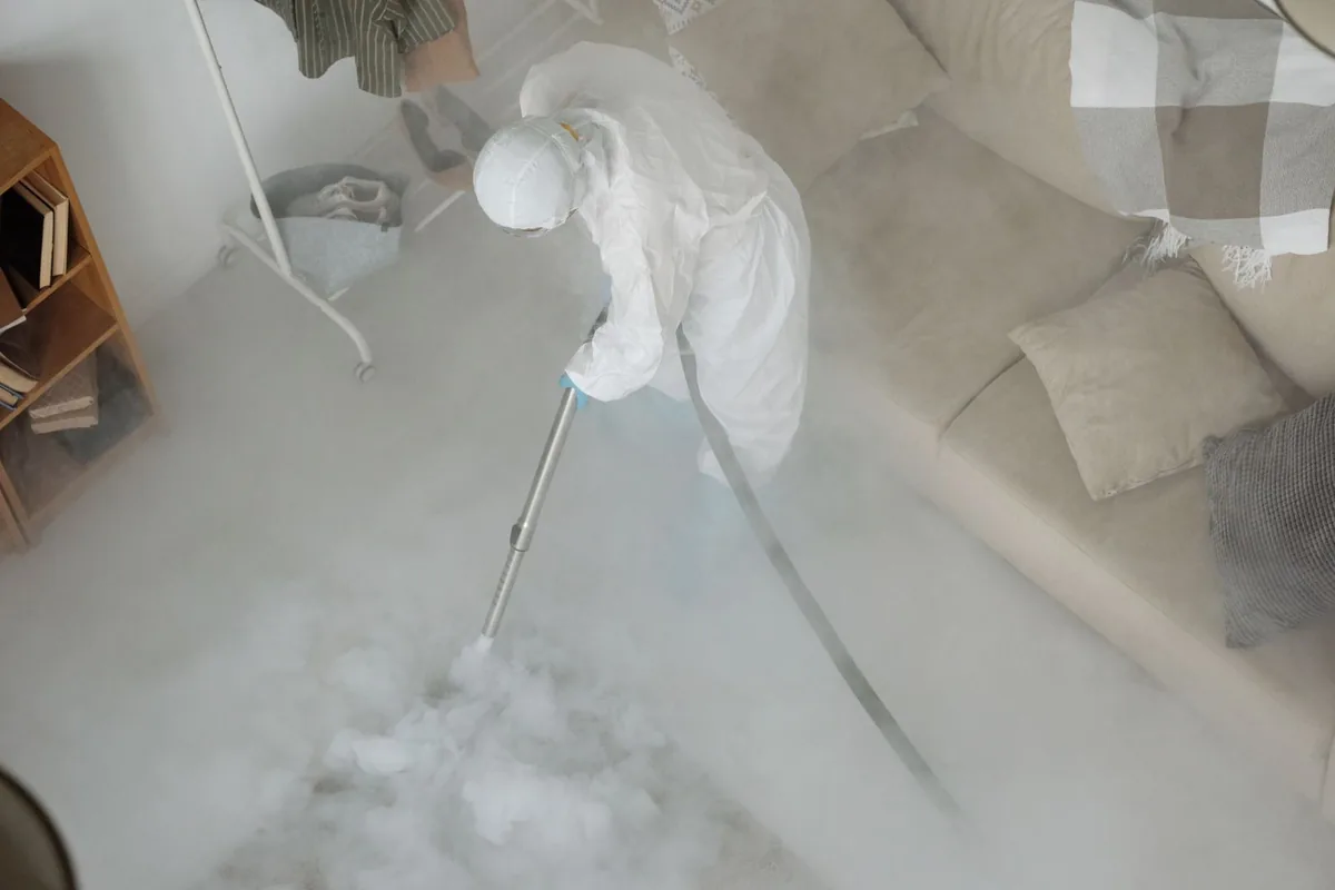 Biohazard cleanup technician in protective equipment, Brownlee Park, MI